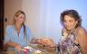 Sara Crawford serving a hot dog to Lisa Cole