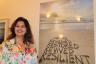 Maliha Kahn, with artist Mark Wylie's work, “Resiliance”